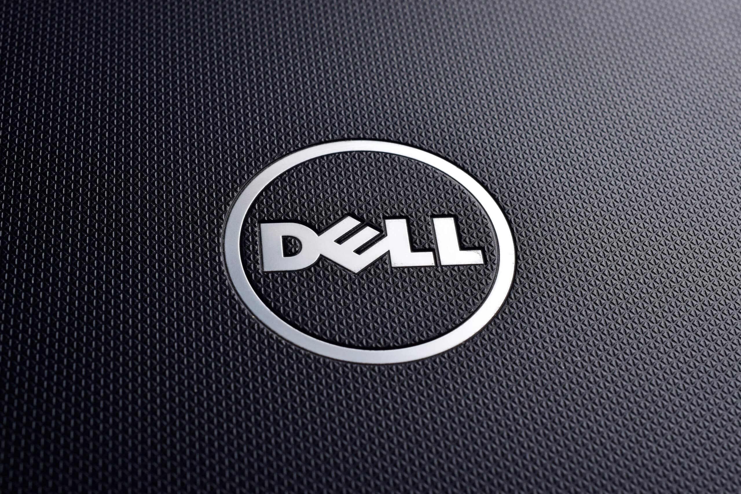 Dell logo on textured black laptop, close up